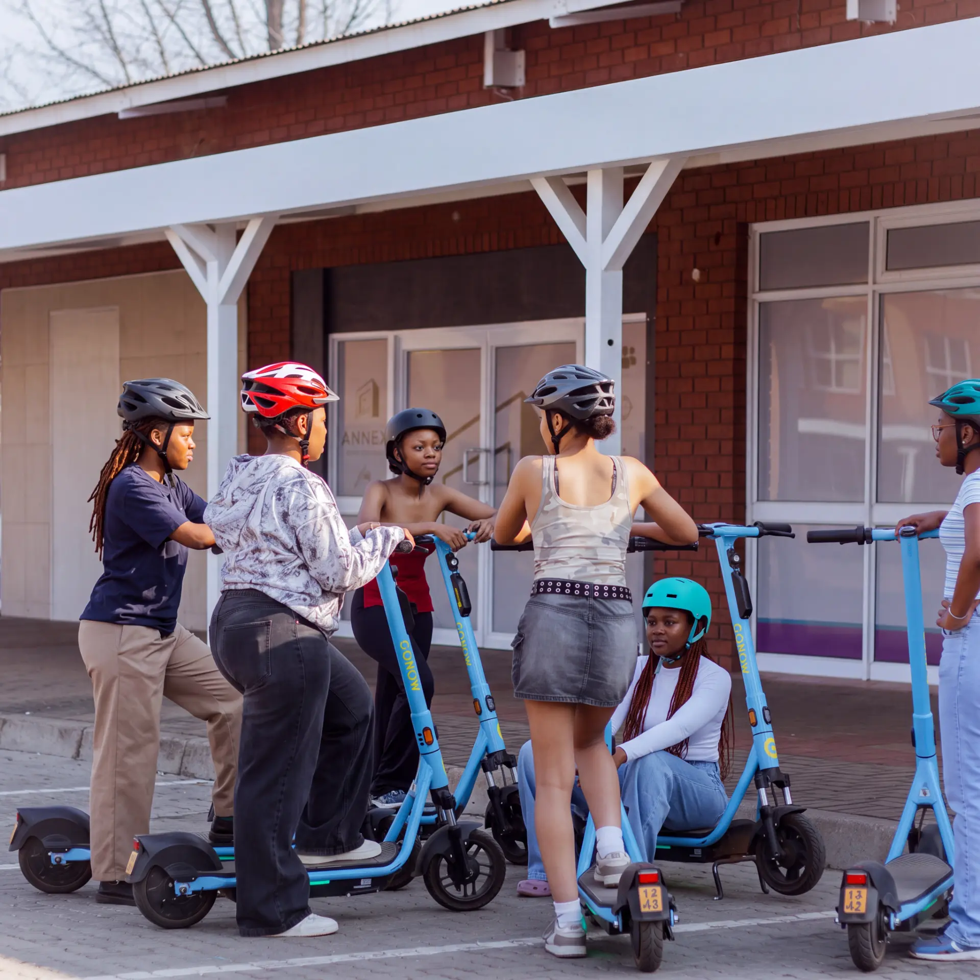 Rider in a helmet on a GONOW scooter on a Stellenbosch street