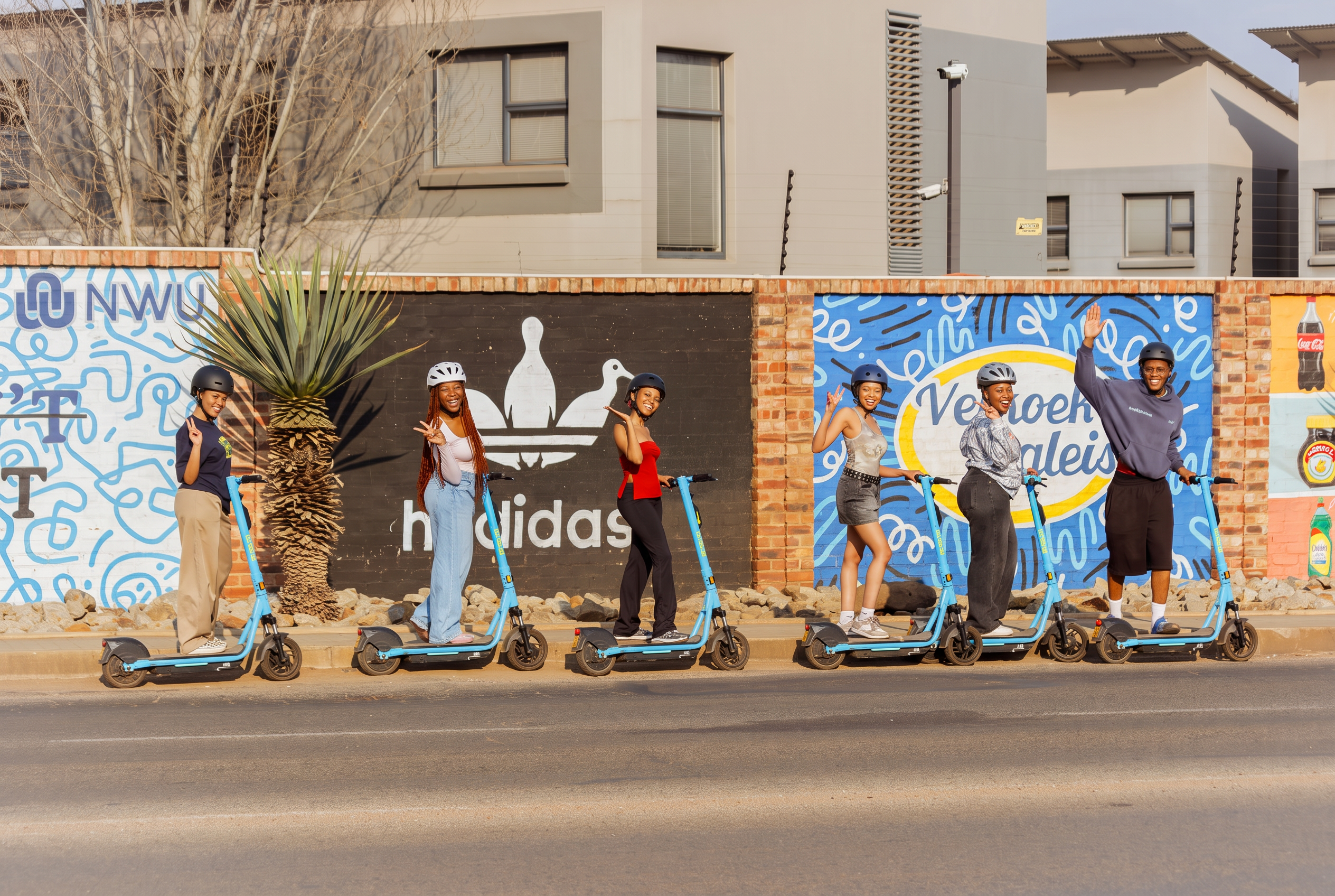 Friends wearing helmets with GONOW scooters in Potchefstroom
